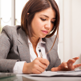 Woman writing down Allergen Plan on a pad of paper